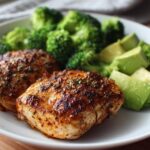 Plate with grilled chicken, steamed broccoli, and avocado chunks for low carb dinners