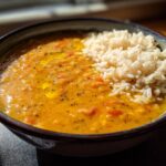 Bowl of hearty lentil soup served with white rice, perfect for ramadan budget friendly dinner ideas