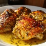 Close-up of herb-seasoned chicken thighs cooked in sauce, showcasing Ramadan instant pot chicken recipes.