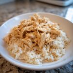 Bowl of shredded chicken served over white rice, an easy instant pot recipe