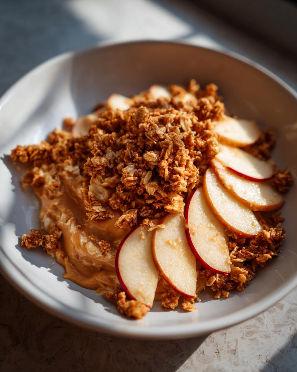 Bowl of peanut butter, sliced apples, and granola for after school snack recipes