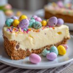 Slice of Easter no bake dessert cheesecake topped with colorful candy eggs and sprinkles