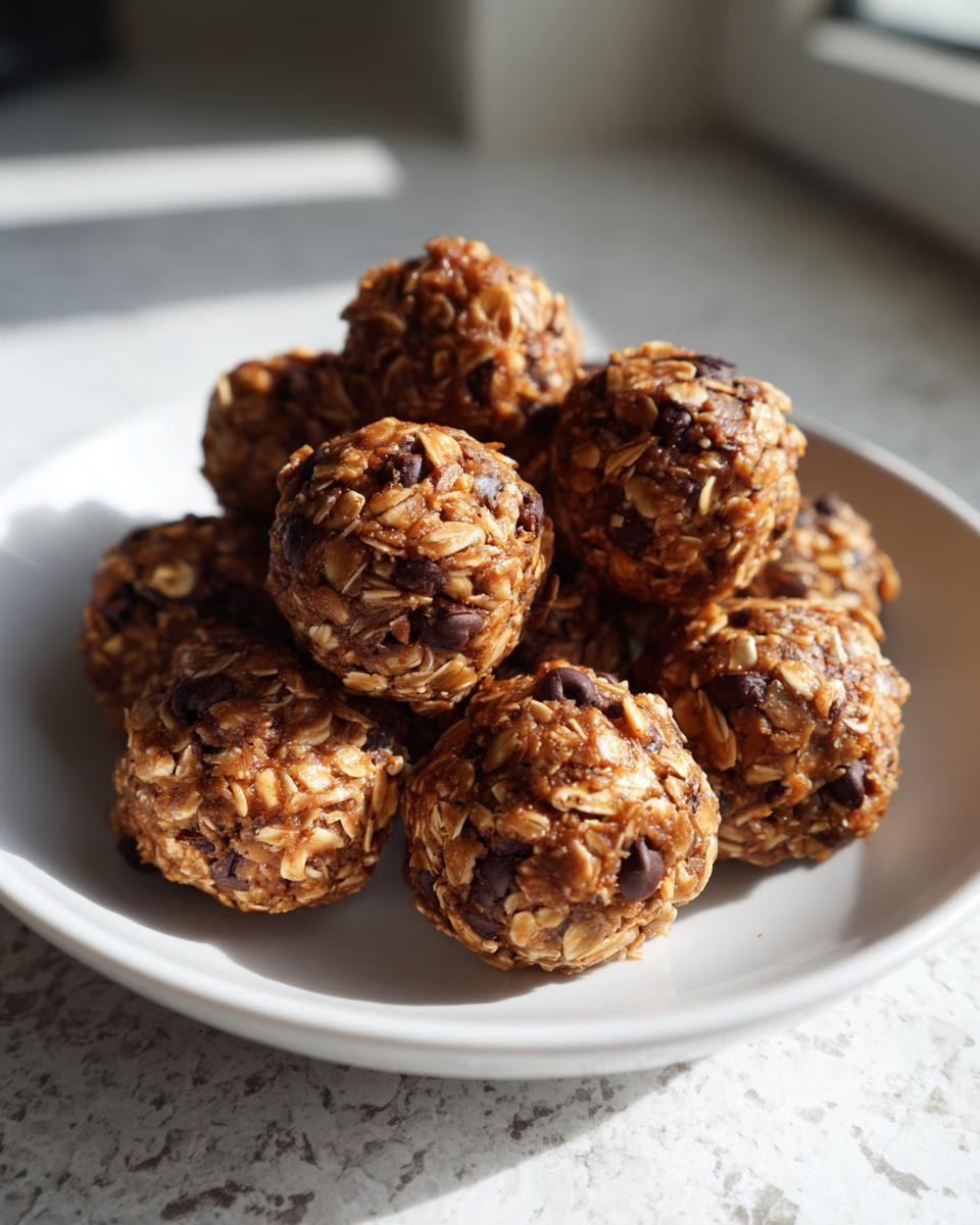 Close-up of no bake snack bites made with oats and chocolate chips on a white plate.