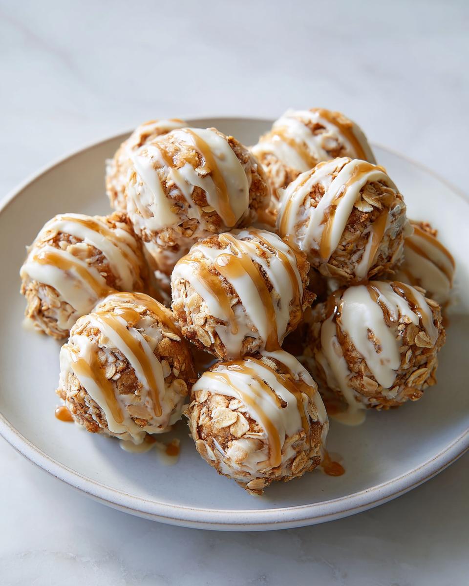 Close-up of peanut butter yogurt snack bites drizzled with yogurt and caramel sauce on a white plate.