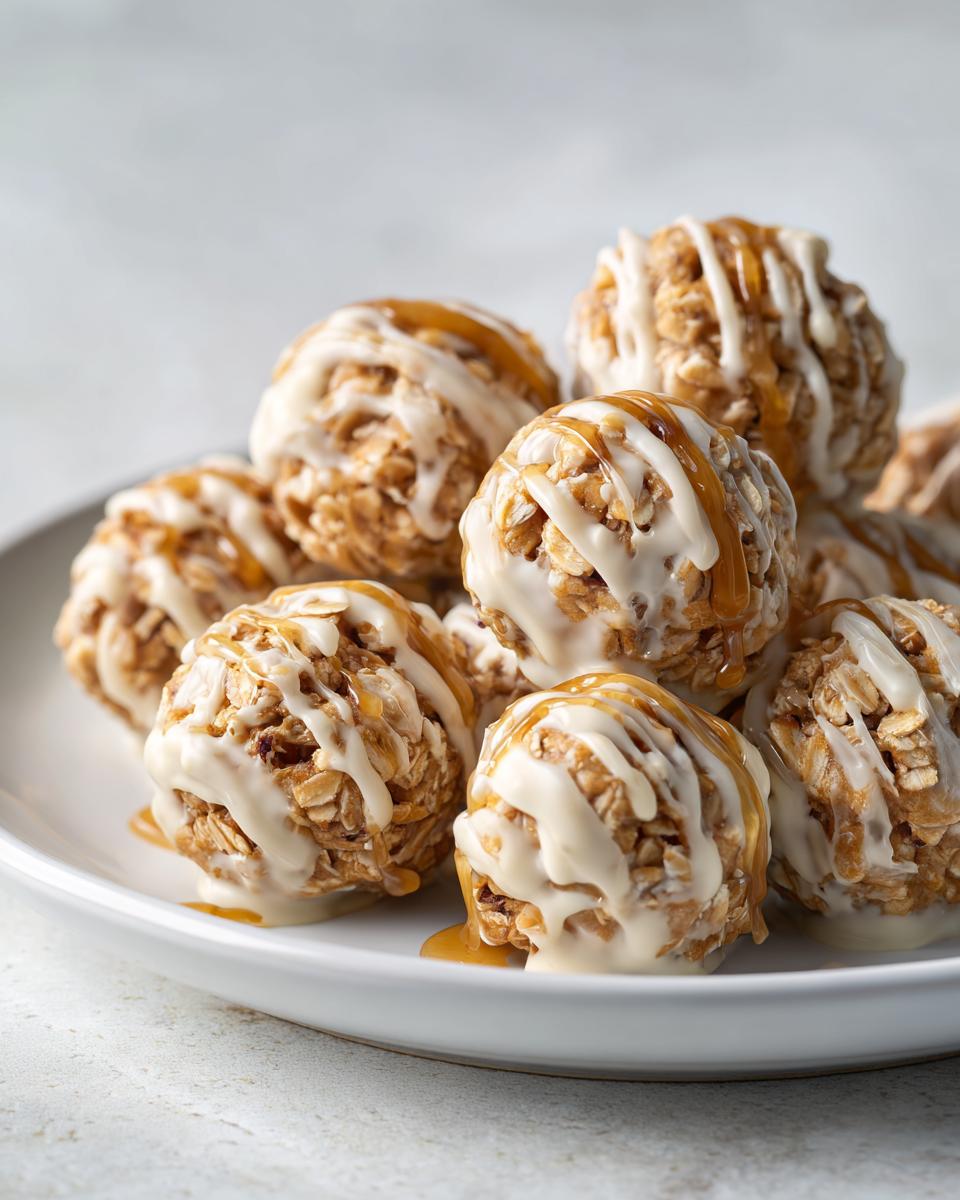 Close-up of peanut butter yogurt snack bites drizzled with white and caramel sauce on a white plate.