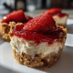 Close-up of strawberry pretzel dessert cups topped with fresh strawberries and strawberry glaze